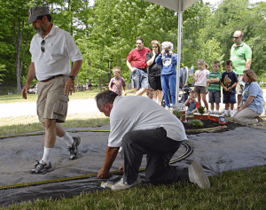 Northern Ohio Garden Railway Society members Allen Nickels and George Kuznar assemble the track on the ground in demonstration of a 'One-Day Railroad.'